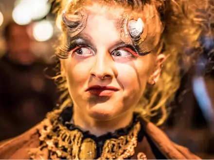 A beaturiful woman with an amazing halloween make-up and horns